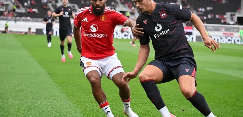 Two players contesting for the ball on field