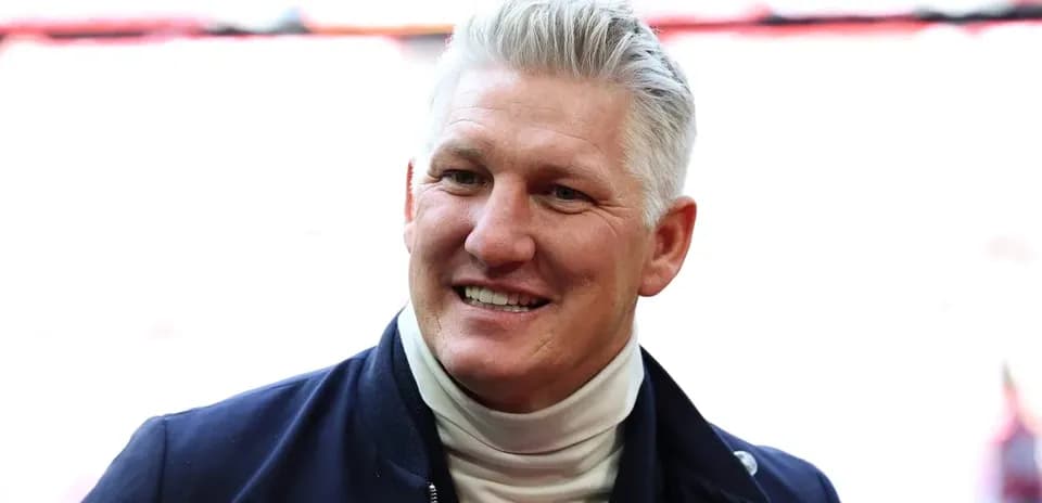 Smiling man in a dark jacket and turtleneck