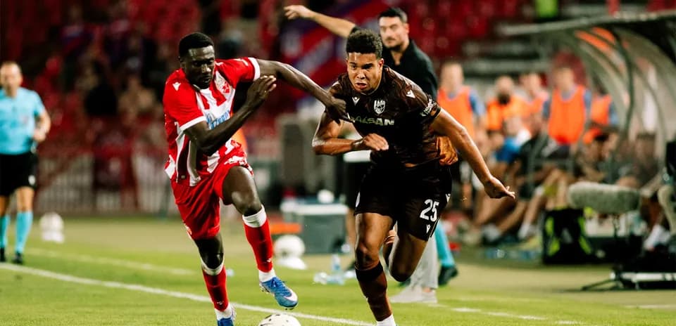 Two players competing for the ball in match