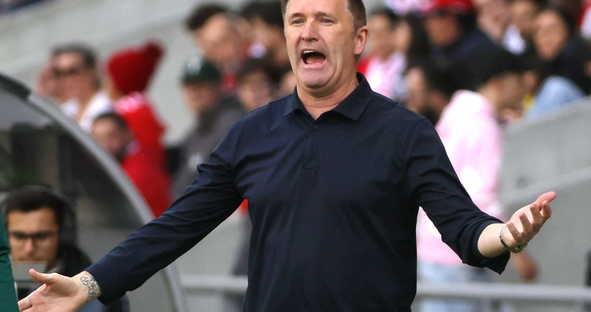 Coach gesturing during a match from the sideline