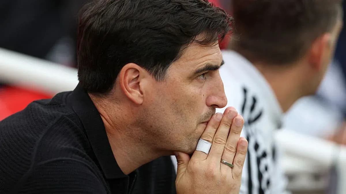 Coach observing the match with focused expression