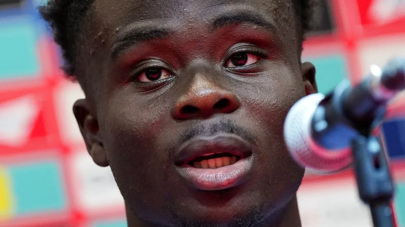 Player speaking into microphone at press conference