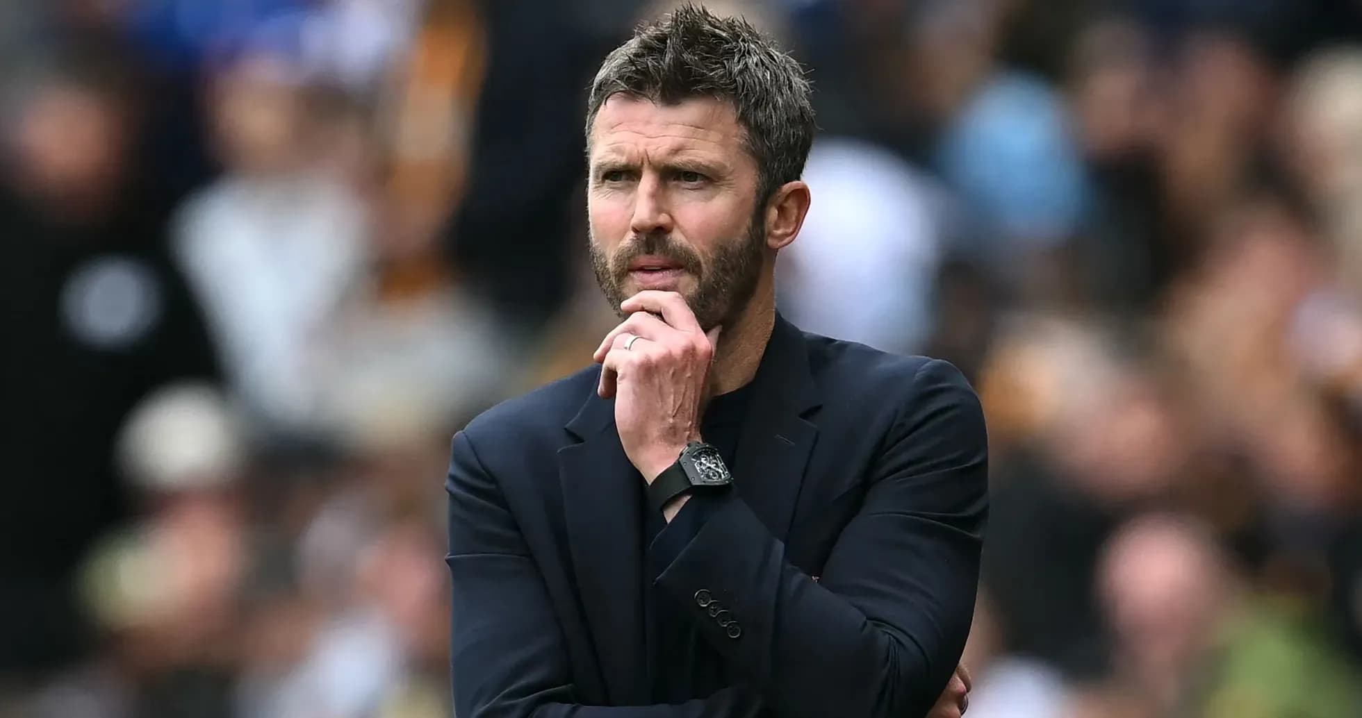 Manager contemplating during a match on the sidelines