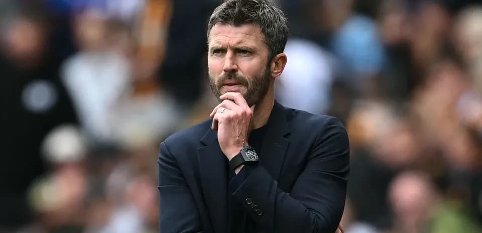 Manager contemplating during a match on the sidelines