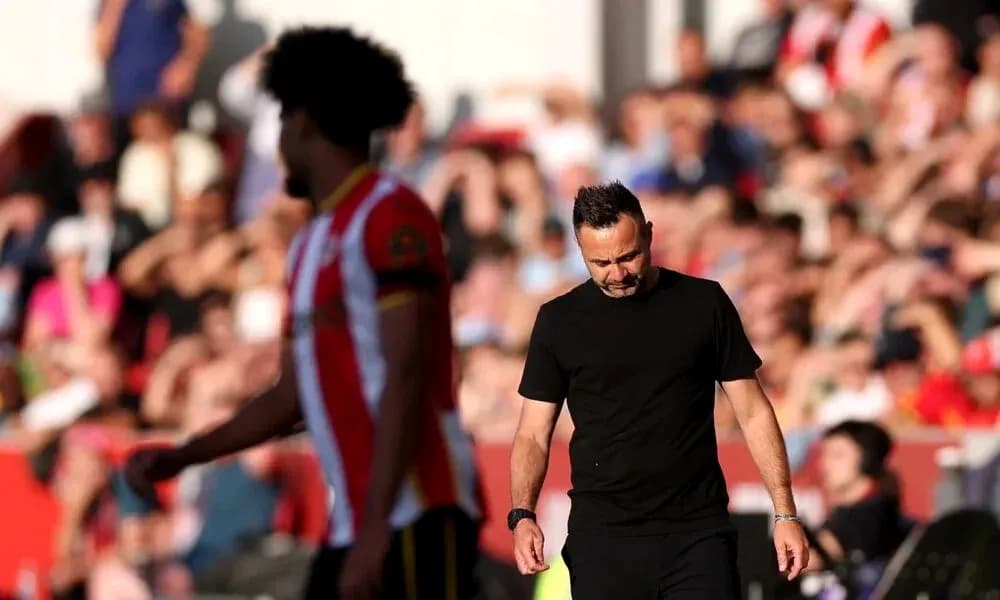 Manager walking past player during match