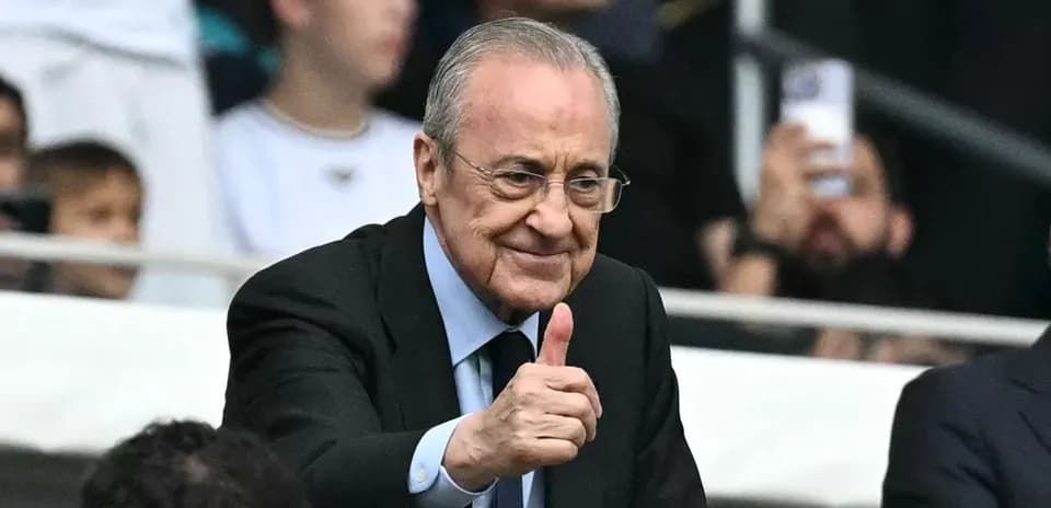 Man giving a thumbs up in a stadium