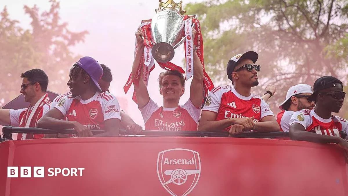 Arsenal players celebrating with Premier League trophy