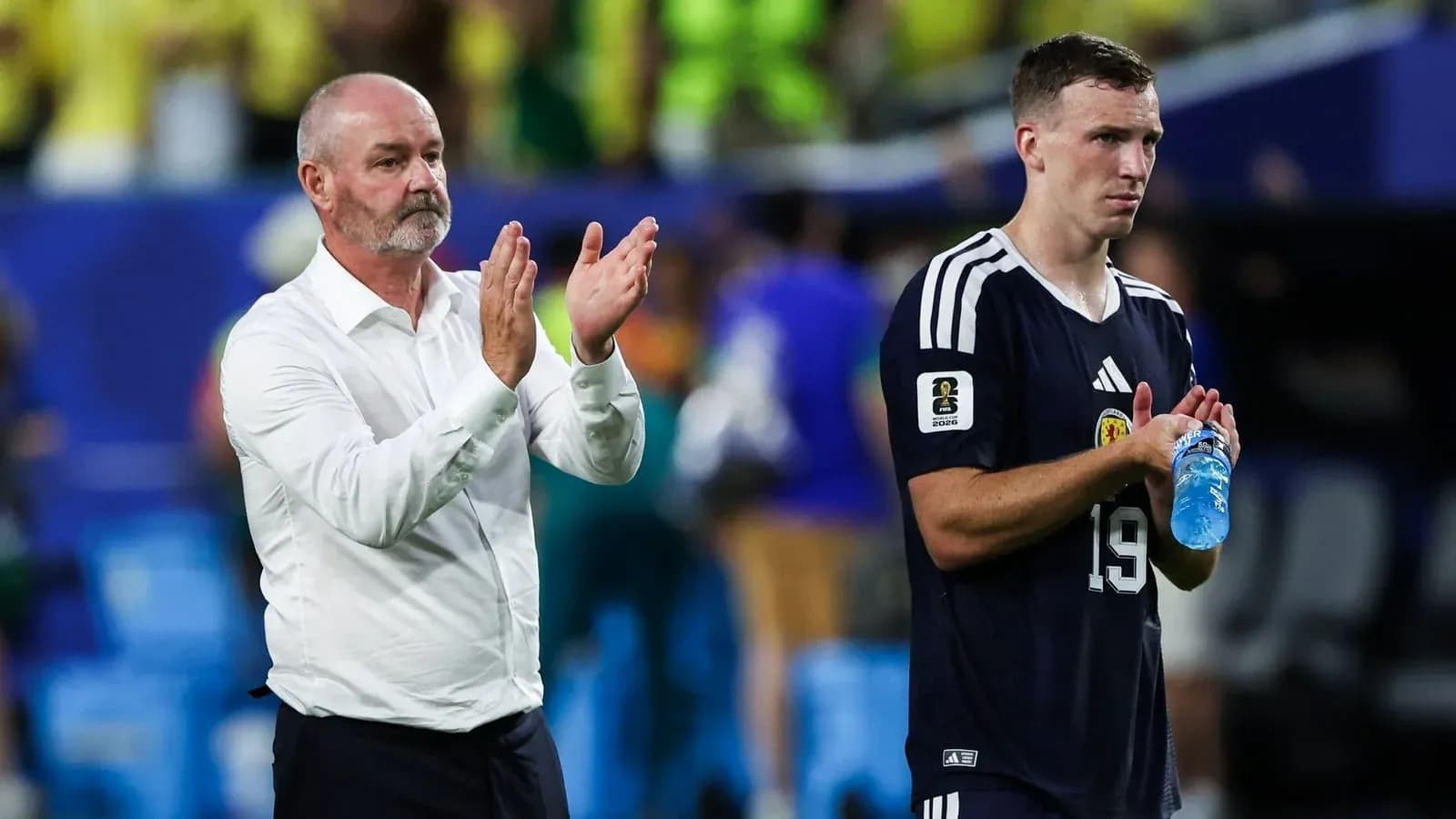 Coach and player applauding after the match