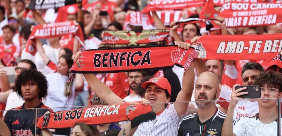 Benfica fans cheering with scarves at match