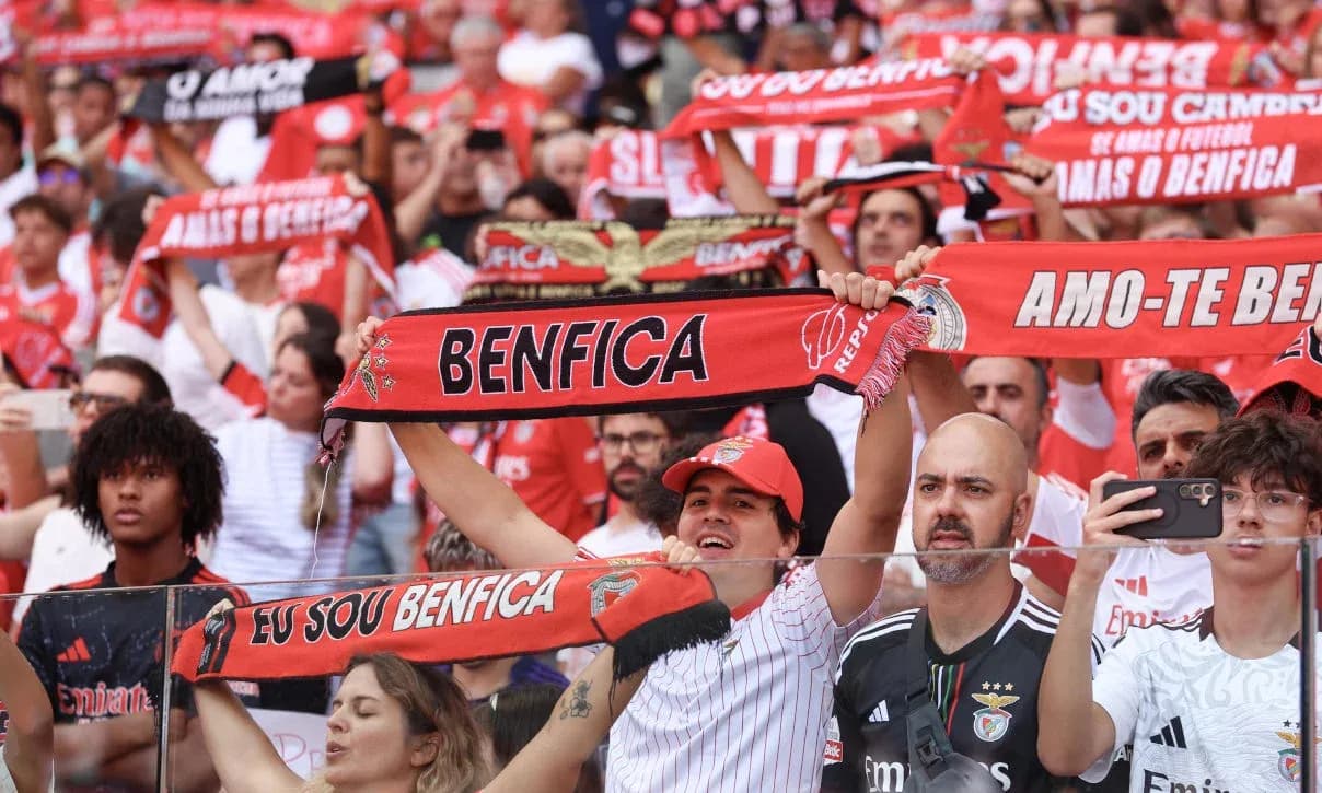 Benfica fans cheering with scarves at match