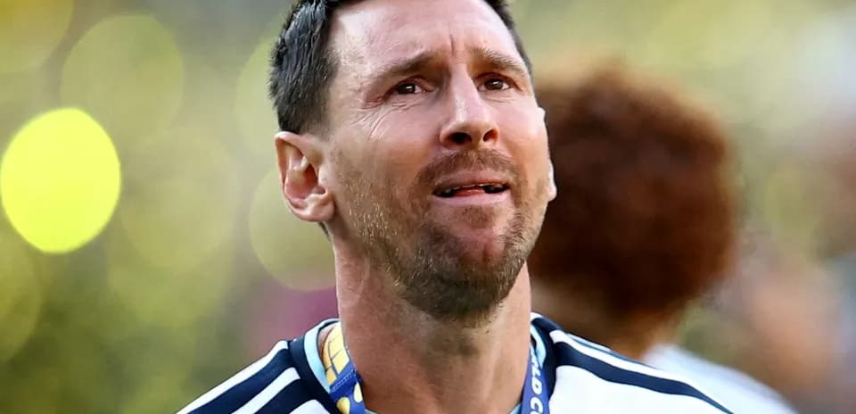 Player wearing Argentina jersey with medal around neck