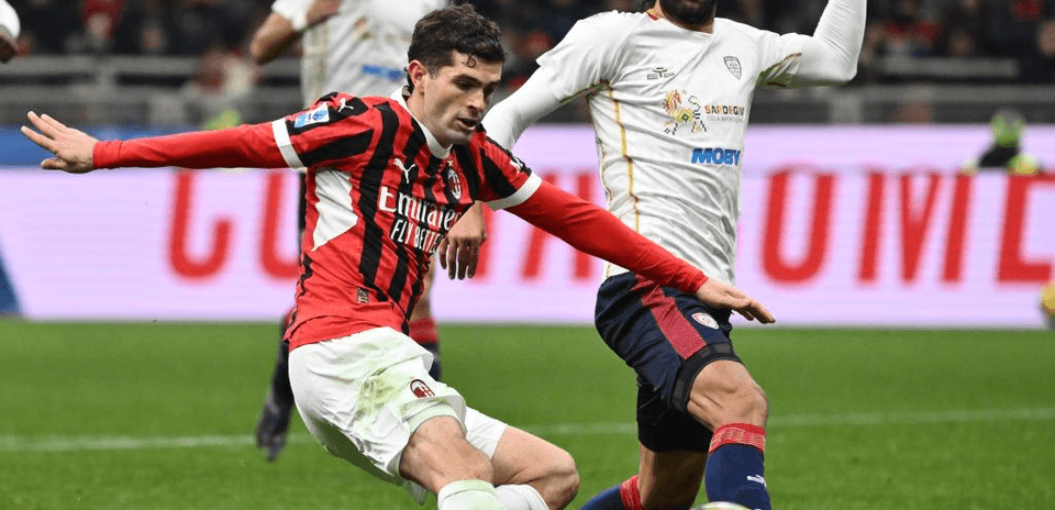 AC Milan player challenges Cagliari opponent for the ball