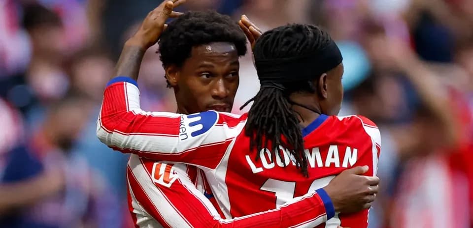 Two Atlético Madrid players celebrating a goal