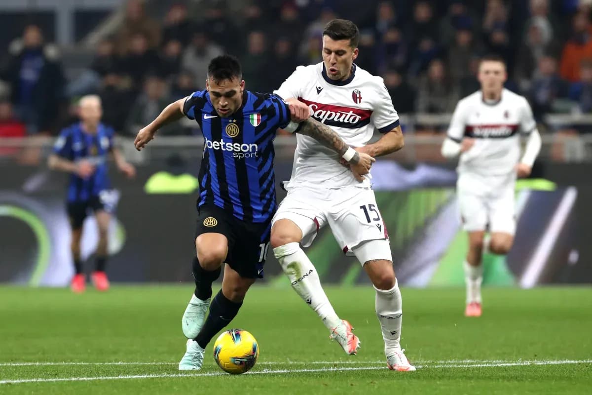 Bologna player challenging Inter player for the ball