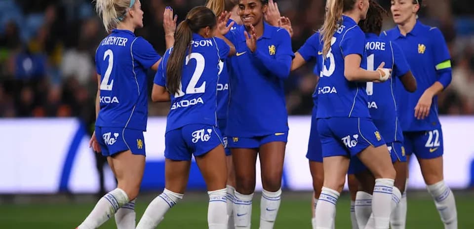 Players celebrating a goal on the field