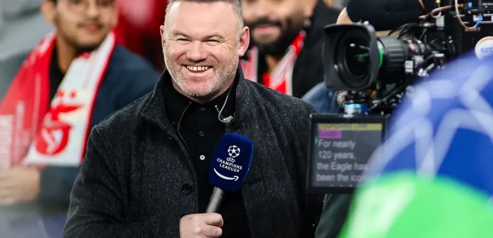 Presenter smiling with microphone at football event