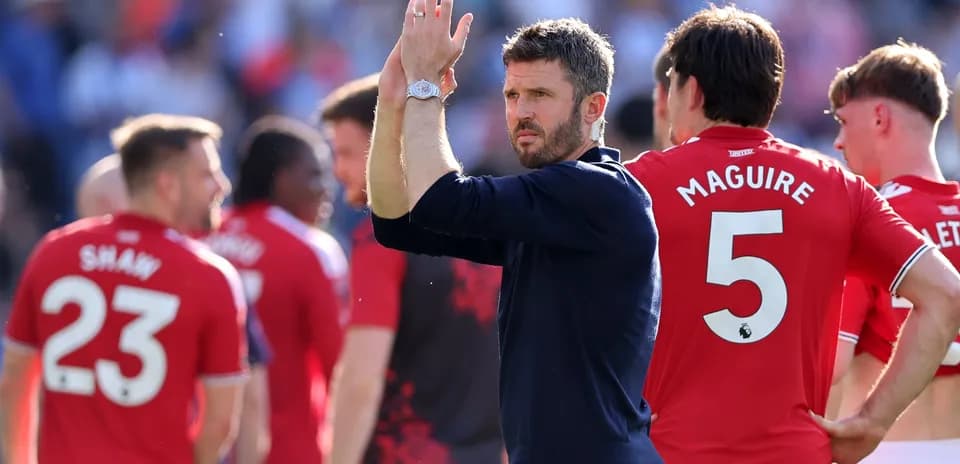 Manager and players applauding fans after match
