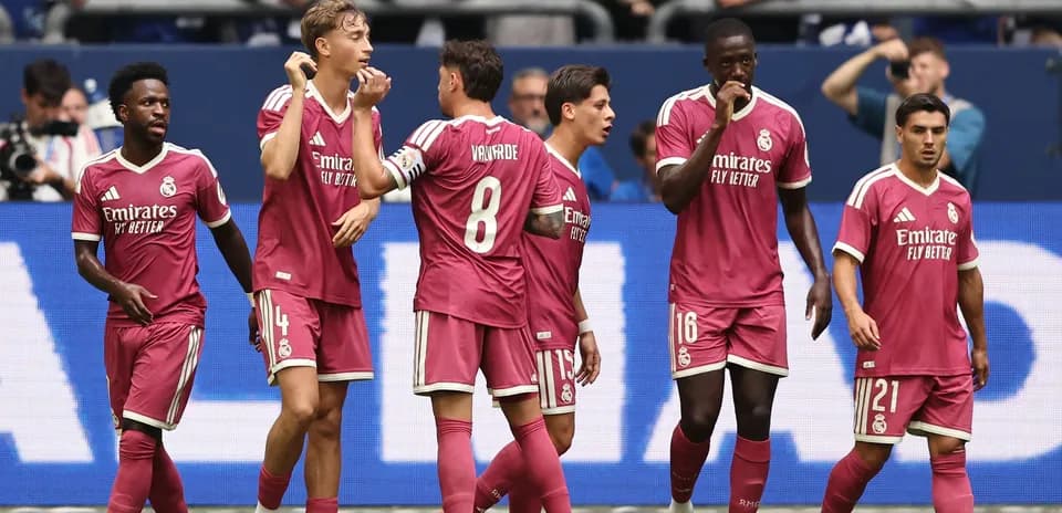 Real Madrid players celebrating a goal on the pitch