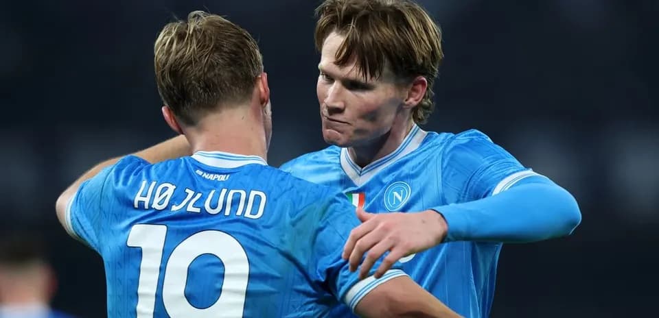 Two Napoli players celebrating on the field