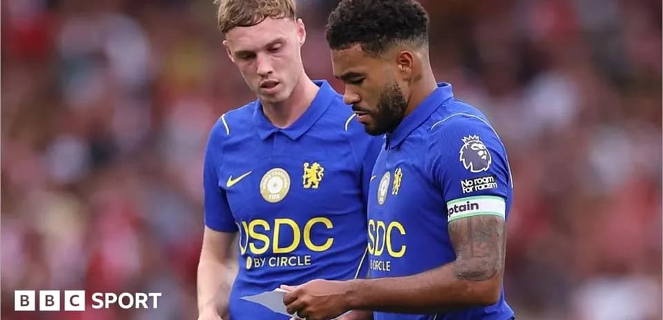 Two Chelsea players discussing strategy during match