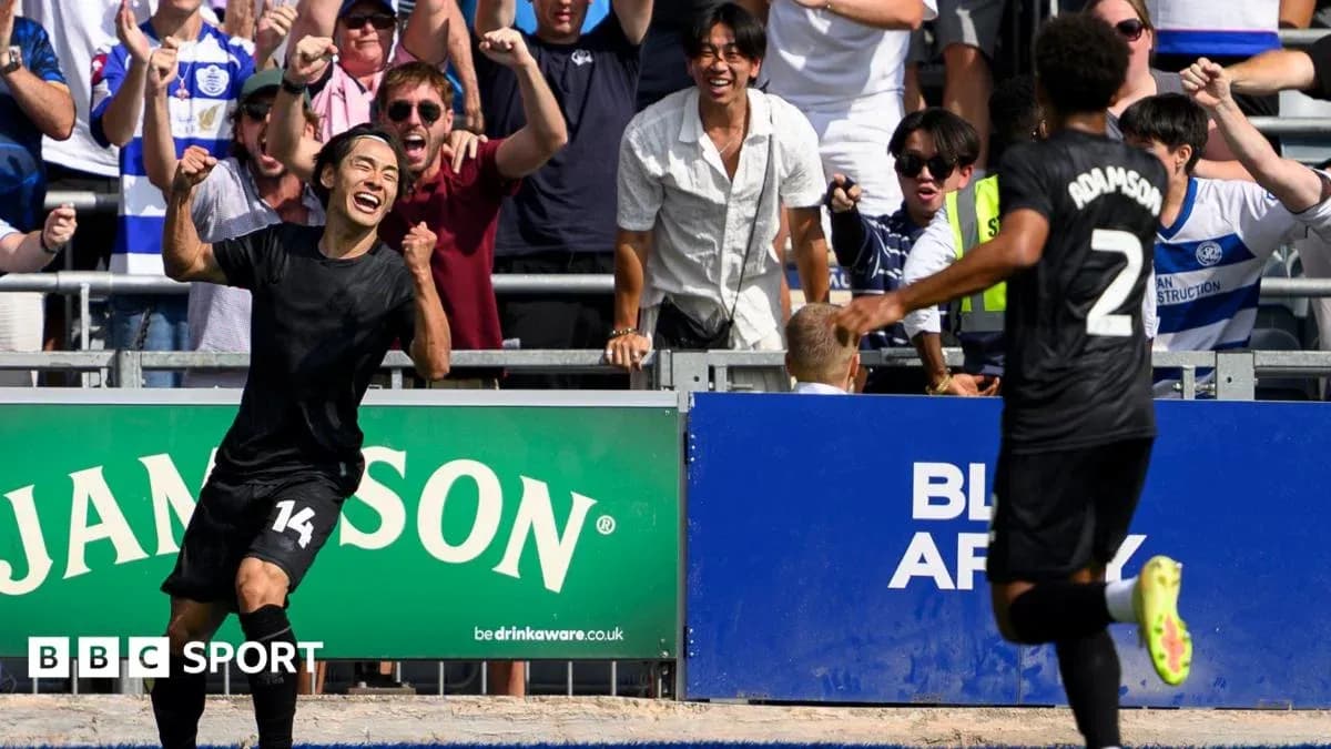 Player celebrating a goal with fans in background