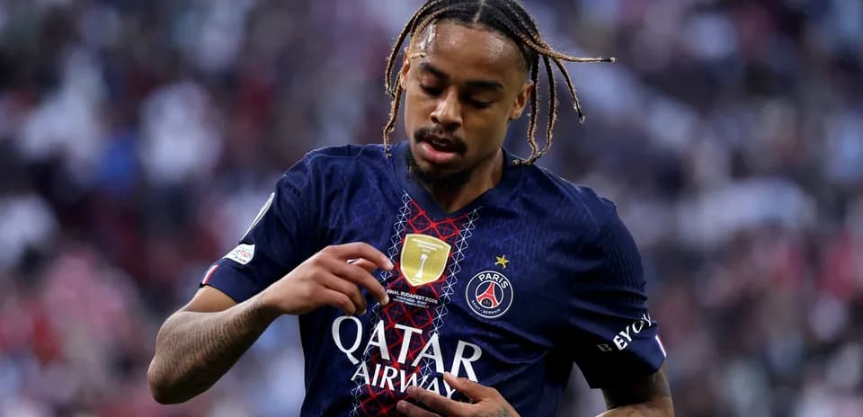 Player adjusting badge on Paris Saint-Germain jersey