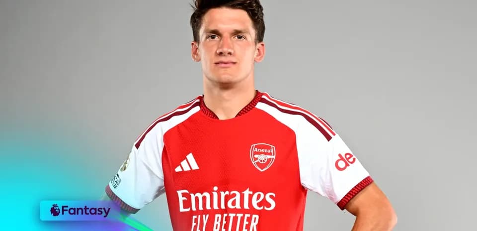 Player posing in Arsenal jersey with sponsor logos