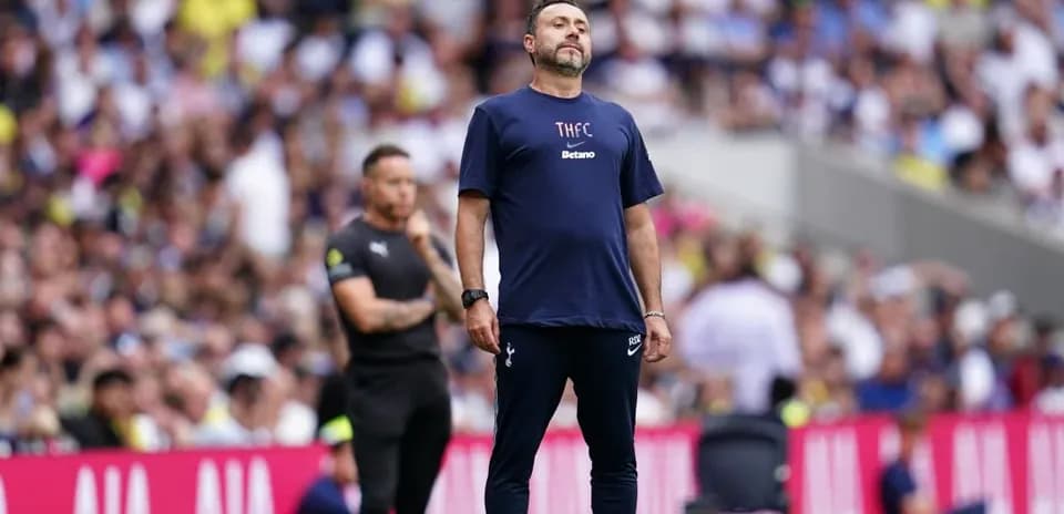Coach observing match from sideline during game