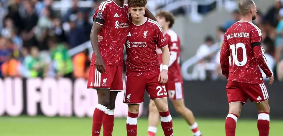 Two Liverpool players in red kits during match