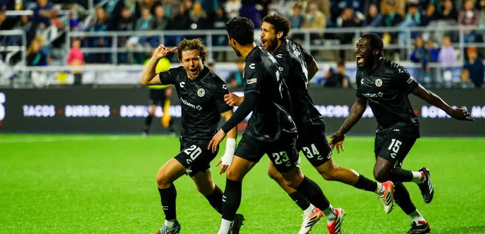 Oakland Roots players celebrating a goal