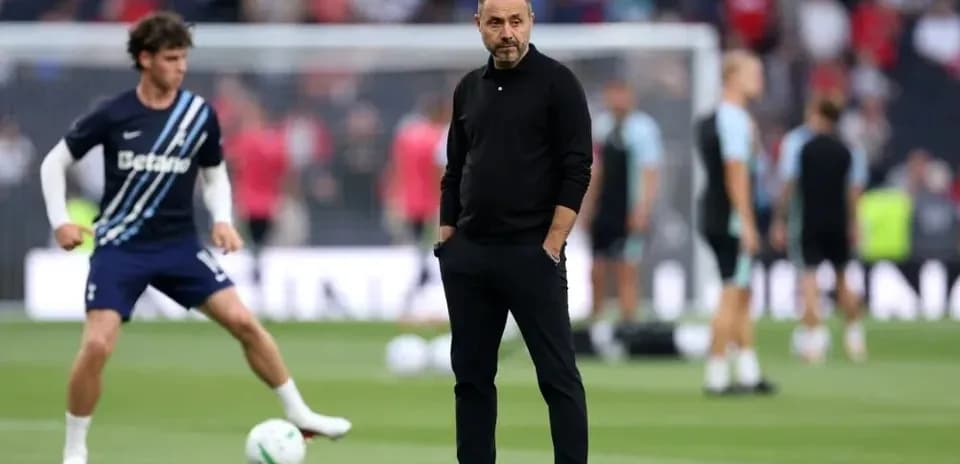 Manager observing players during warm-up on pitch