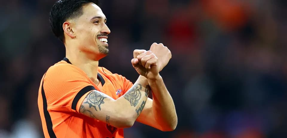 Player celebrating with crossed arms in orange jersey