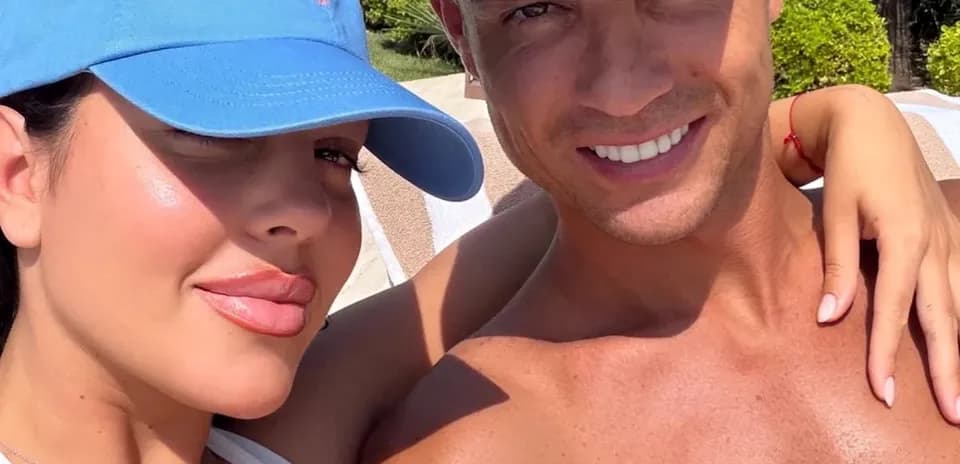 Couple posing for selfie by poolside