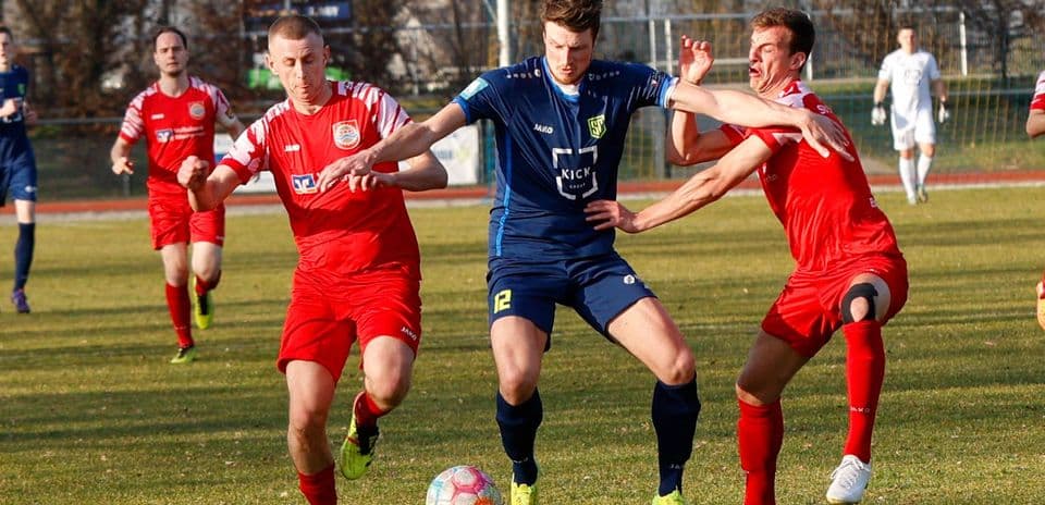 Players competing for the ball in football match