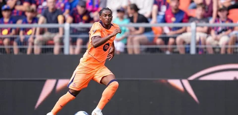 Player in orange kit sprinting on the field