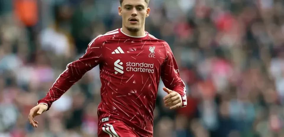 Player in red Liverpool kit running on the pitch