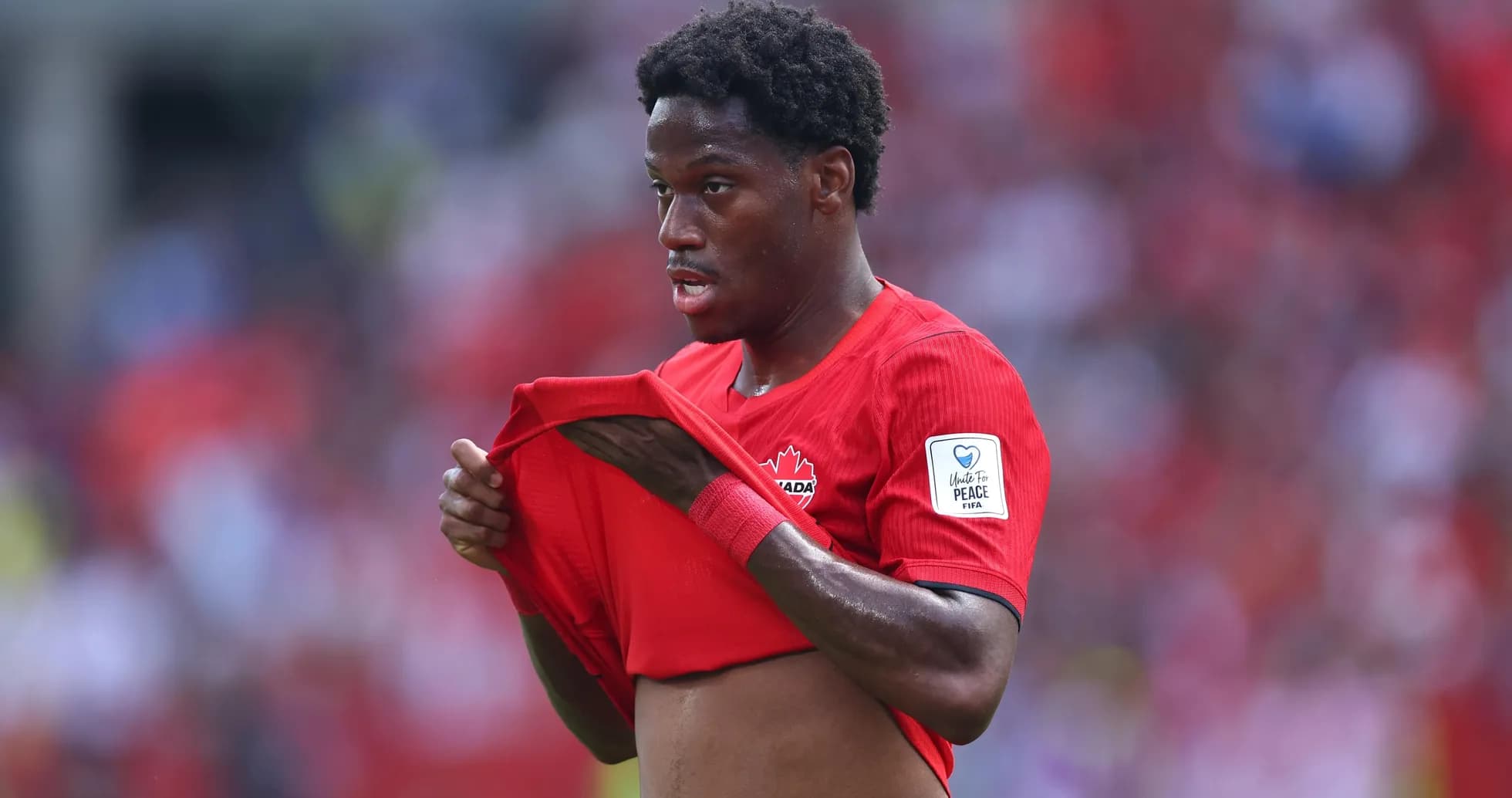 Canadian player adjusting jersey during match