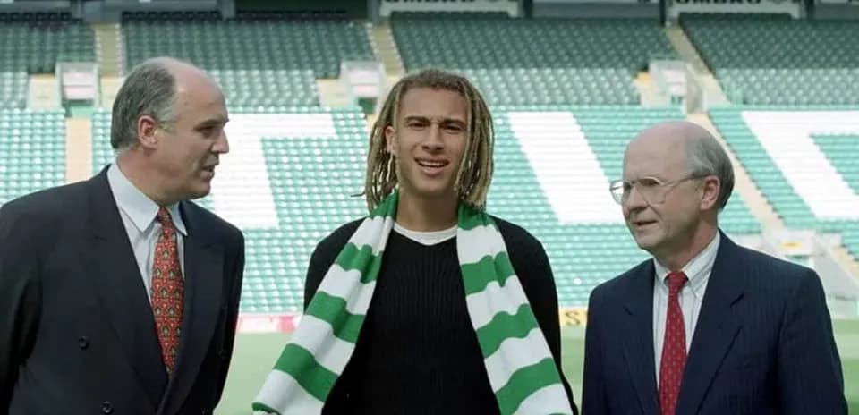 New player holding scarf at club announcement event