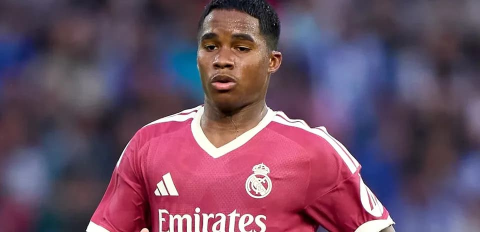 Player wearing pink Real Madrid jersey on field