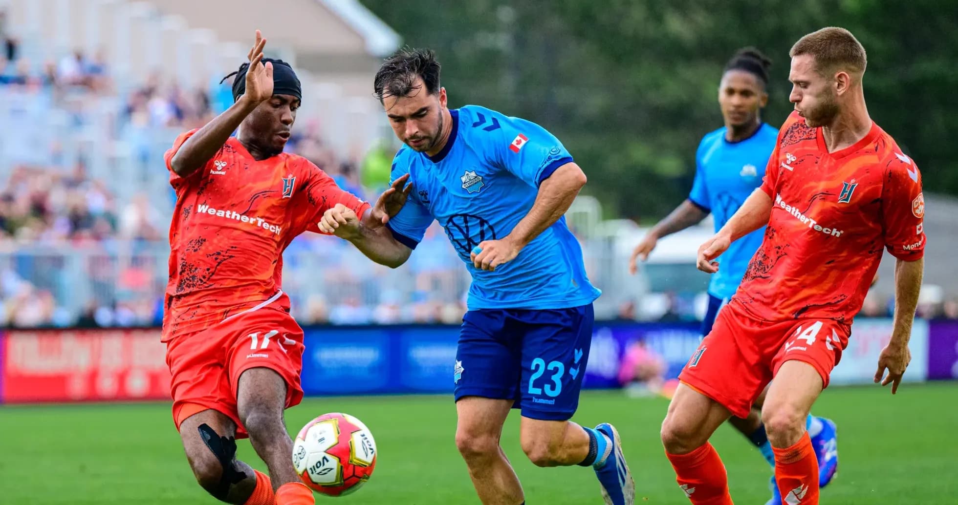 Two players competing for the ball in football match