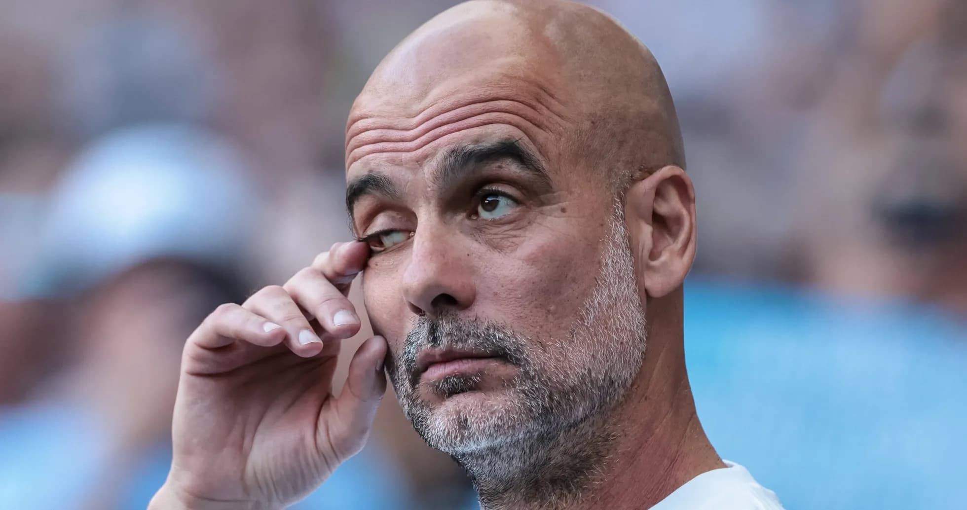Manager with hand on face during match