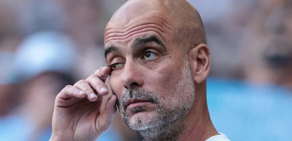 Manager with hand on face during match