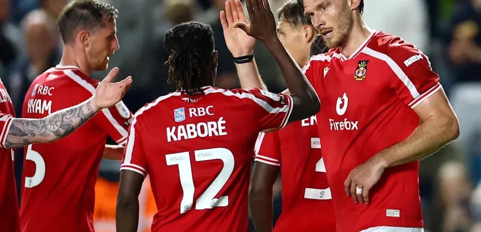 Players celebrating a goal on the pitch