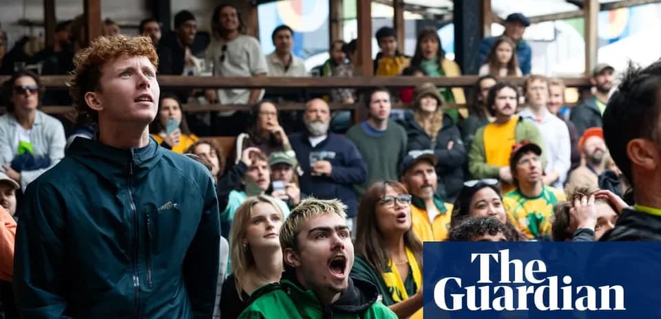 Crowd watching sports event with varied expressions