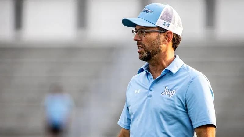 Coach speaking on the sidelines during a match