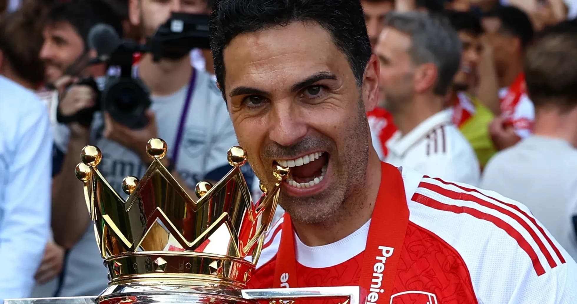 Manager celebrating with Premier League trophy