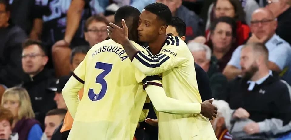 Two players embracing on the sidelines during match