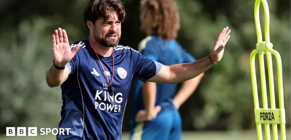 Coach directing players during training session