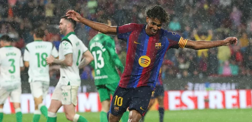 Barcelona player celebrating in the rain during match