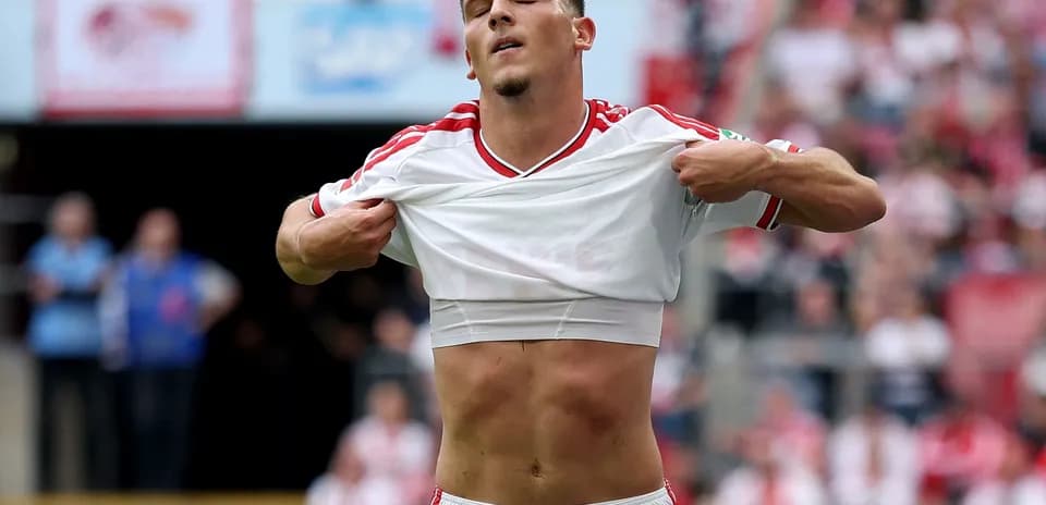 Player removing shirt on the field during match